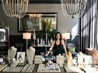 Natalie standing in a stylish interior setting selling Bijou Indochine Jewelry