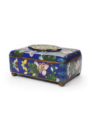 Blue Clossione box with floral and butterfly design on a blue background.