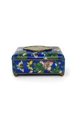 Blue Clossione box with floral and butterfly design on a blue background.