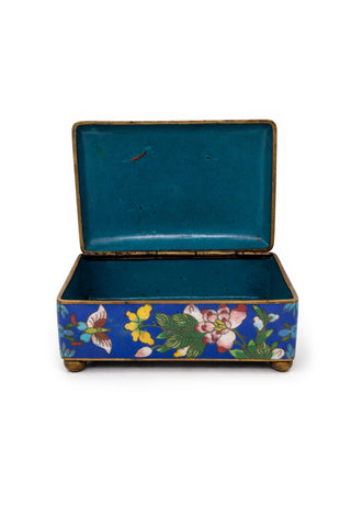 Blue Clossione box with floral and butterfly design on a blue background.