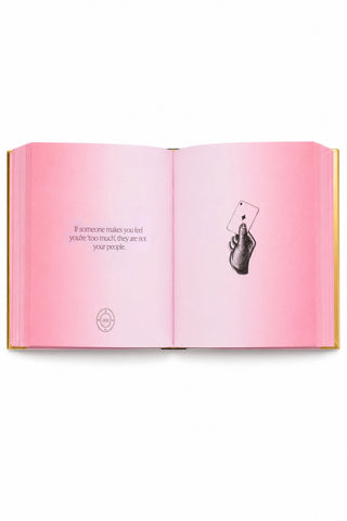 Inside of Book of Answers by Gaia Elliot, book with pink pages on white background.