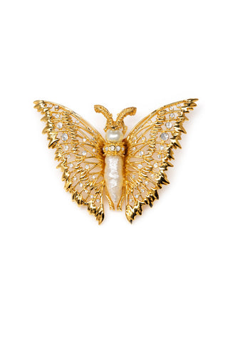 Gold butterfly brooch with pearl center on a white background