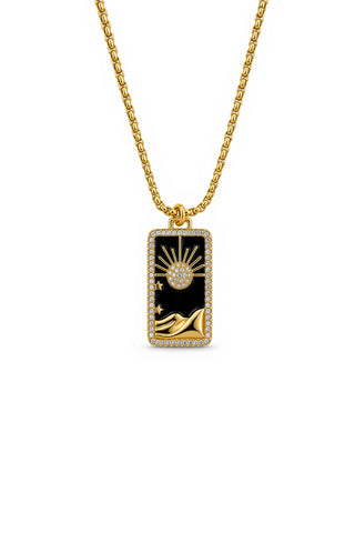 Gold necklace with a rectangular pendant featuring a design of a desert and sun on a white background
