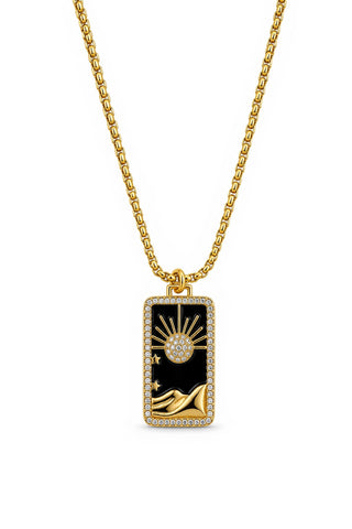 Gold necklace with a black pendant featuring celestial design on a white background