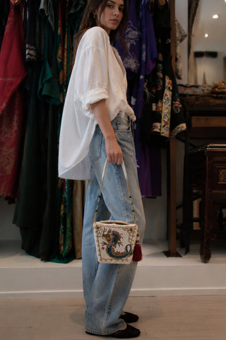 Woman holding a handbag in a clothing store