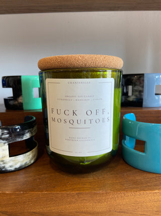 Candle with a humorous label on a shelf