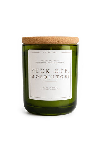 Green candle with a cork lid and humorous label on a white background