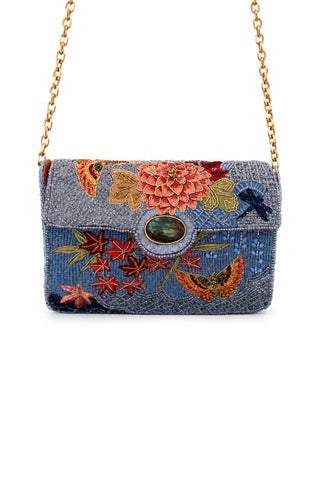 Embroidered floral clutch bag with a gold chain on a white background