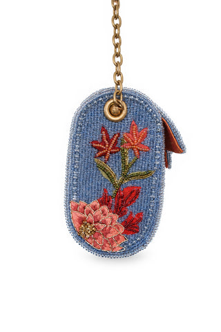Beaded purse with floral design and gold chain on a white background
