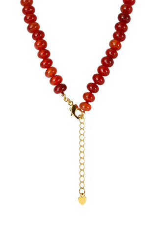 Red carnelian beaded necklace with a gold heart shaped clasp on a white background
