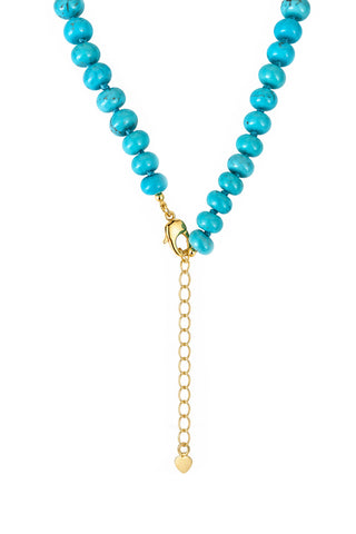 Turquoise beaded necklace with a gold clasp and heart charm on a white background