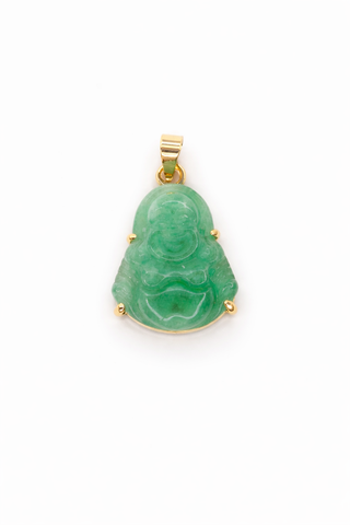 Green jade pendant with gold prongs on a white background