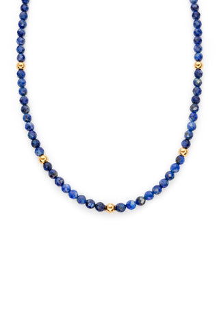 Blue lapis beaded necklace on a white background