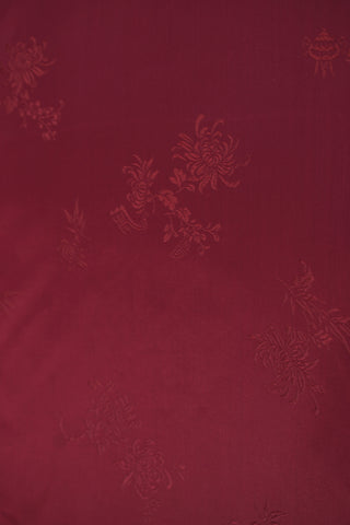Maroon fabric with floral brocade pattern.