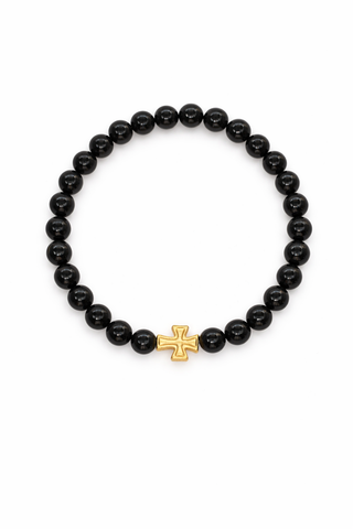 Black beaded bracelet with a gold cross charm on a white background