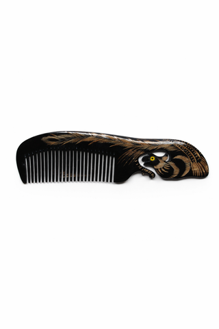 Ox horn hair comb in black on a white background