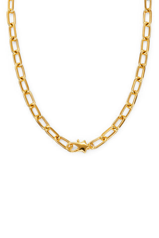 Star shaped clasp on a gold paperclip chain necklace on white background