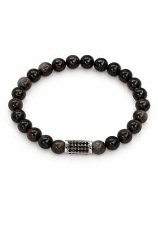 Black glossy beaded bracelet with a silver pavé bead on a white background