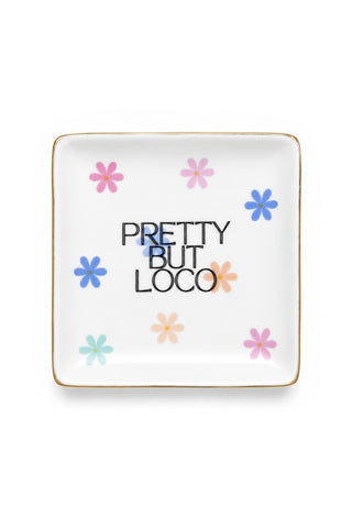 Square white plate with floral designs and 'Pretty But Loco' text on a white background