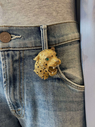 Gold leopard brooch on a denim jeans