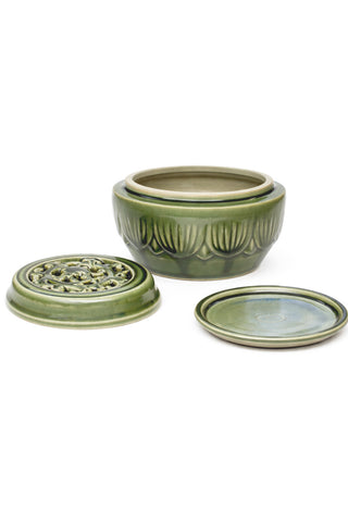 Three pieces of a green ceramic incense burner on a white background