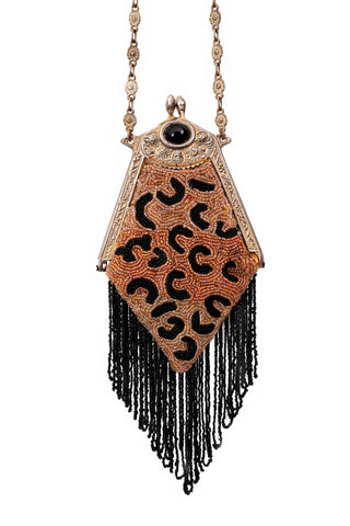 Vintage handbag with beaded leopard design on a white background.