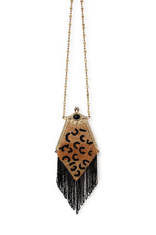 Vintage handbag with beaded leopard design on a white background.
