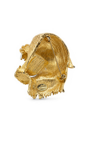 Gold leopard head brooch on a white background