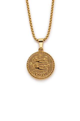 Gold necklace with a Gemini pendant on a white background
