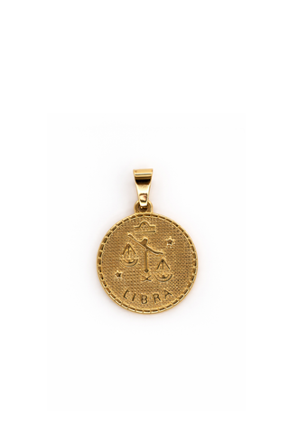 Gold Libra zodiac pendant on a white background