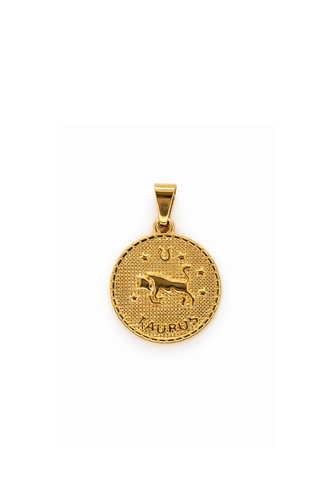 Gold Taurus necklace pendant on a white background